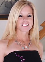 Busty mature Monique slides black dress off her tight body.