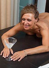 Mature babe Drugaya enjoys cocktails while being naked.