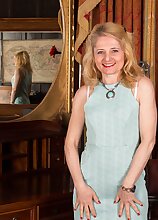 Stocking wearing mature woman Lily Roma is butt naked on her desk.