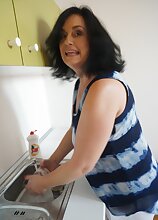 Mature housewife Ria Black gets naked on the kitchen counter.