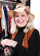 Busty older babe Judy Belkins spreads pussy in closet.