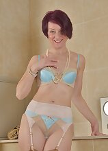 Older babe Penny Brooks toys pussy in the bathroom.