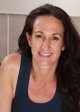 Mature amateur Genevieve Crest exposes her trimmed pussy.