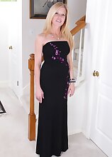 Busty mature Monique slides black dress off her tight body.