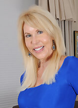 Elegant 60 year old Erica Lauren slip out of her sleek blue dress
