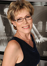 Elegant 57 year old Georgina C uses her glasses to toy her pussy